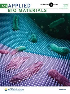 The front cover of ACS Applied Bio Materials. The cover shows engineered pillars with different flexibilities that can kill bacteria.