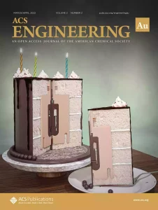 The front cover of ACS Engineering Au. The cover shows a cake with a chemical reactor at the center.
