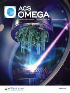 ACS Omega cover art. Here, GaN nanowires can be seen hanging in a vacuum chamber, with a laser beam ejecting ions.